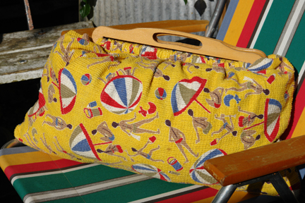 vintage beach bag made of bright yellow 1950s towelling fabric with beach umbrella and male & female swim-suited figures pattern