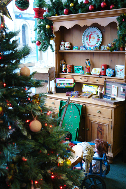 Christmas tree and vintage Christmas decorated shop window in Picture House Antiques in Todmorden