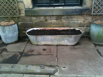 pair of galvanised dolly tubs and large tin bath prepared for planting