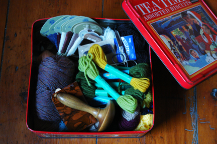 vintage Frears "Tea Time" Christmas assorted biscuit tin with its lid off showing its contents to be vintage darning materials