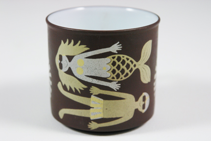 detail from a vintage "July" mug produced by Hornsea Pottery showing a man and a mermaid sunbathing detail from a vintage "July" mug produced by Hornsea Pottery showing a man and a mermaid sunbathing