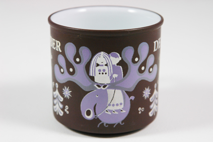 detail from a vintage "December" mug produced by Hornsea Pottery showing a couple riding a reindeer detail from a vintage "December" mug produced by Hornsea Pottery showing a couple riding a reindeer
