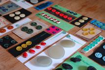 sewing vintage buttons on to card in preparation for H is for Home's 1st vintage fair