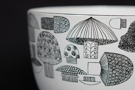 detailed view of a large, vintage Finel enamel bowl decorated with mushroom pattern
