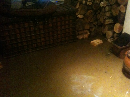 antique chest in our sitting room with flood water surrounding it