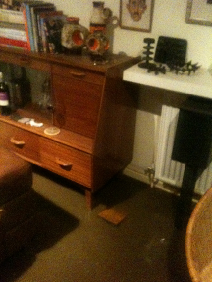 A 1950s G Plan sideboard in our sitting room with flood water surrounding it