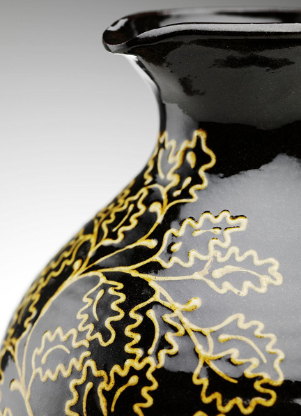 detail from handmade jug slip decorated with oak leaves by potter Hannah McAndrew