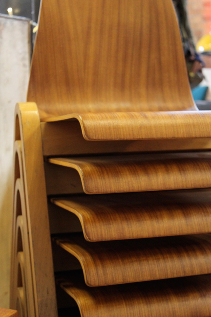collection of stacked vintage wooden chairs
