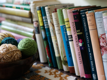 Antique dairy bowl with wool and vintae gardening books on a chest of drawers in H is for Home's master bedroom