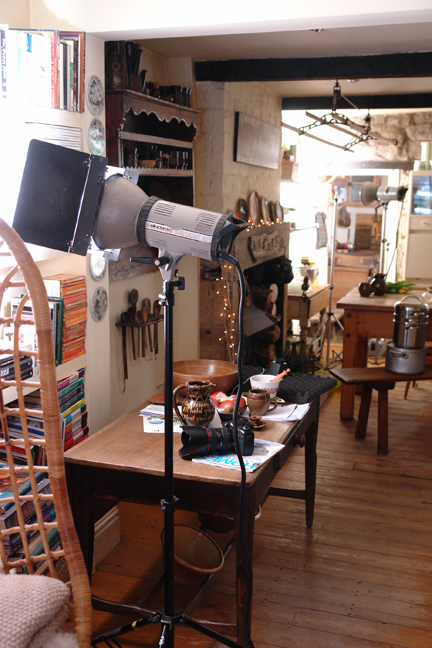 photography light illuminating a shelf in our sitting room with a view through to our kitchen and laundry area
