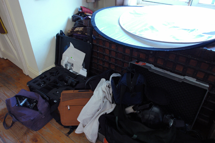 photography equipment in a pile on the floor of our sitting room