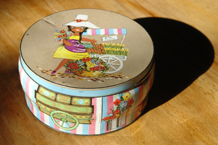 vintage biscuit tin with illustration by Lefor-Openo of a flower seller girl with her market stall