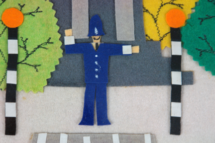 detail of felt artwork depicting a London policeman at a zebra crossing between a pair of Belisha beacons detail of felt artwork depicting a London policeman at a zebra crossing between a pair of Belisha beacons