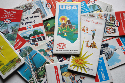pile of vintage travel maps from the 1960s