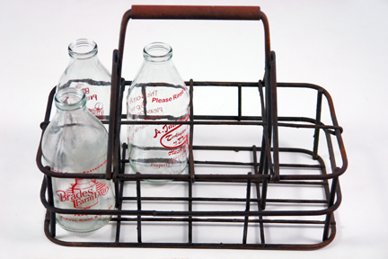 vintage metal milk carrier with vintage milk bottles