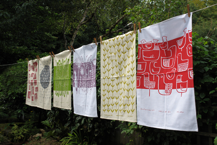 washing line display of 100% cotton hopsack tea towels designed and hand screen printed by Skinny laMinx in Cape Town, South Africa washing line display of 100% cotton hopsack tea towels designed and hand screen printed by Skinny laMinx in Cape Town, South Africa