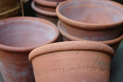 stack of terracotta pots from a selection of vintage garden items stack of terracotta pots from a selection of vintage garden items