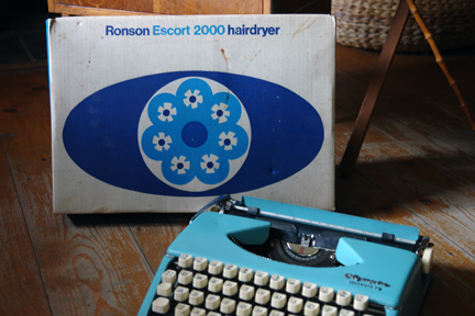 vintage blue Olympia "Splendid 99" typewriter with boxed Ronson "Escort 2000" hairdryer in the background vintage blue Olympia "Splendid 99" typewriter with boxed Ronson "Escort 2000" hairdryer in the background