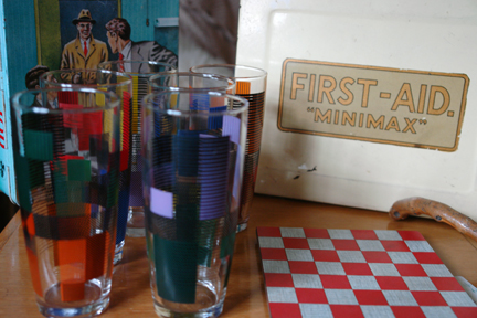 vintage "mini-max" first aid tin and vintage 1950s drinking glasses and chequered pot stand vintage "mini-max" first aid tin and vintage 1950s drinking glasses and chequered pot stand