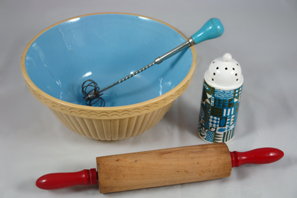 group of vintage kitchenalia items soon to be added to the H is for Home website including a wooden rolling pin with red handles, pottery mixing bowl with blue interior, pottery sifter made by Portmeirion and a metal swizzle stick with blue painted wooden handle