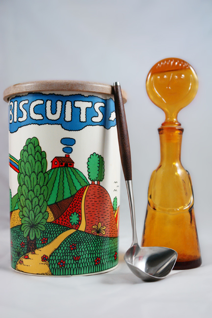selection of recently acquired vintage shop stock for H is for Home including a Scandinavian teak handled stainless steel ladle, pottery biscuit barrel and glass bottle with stopper in the shape of a head