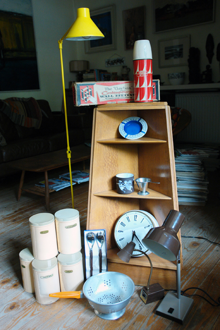 selection of vintage items to be shortly added to the H is for Home shop including triangular corner shelf unit, desk lamps, bright yellow Habitat floor lamp, 1950s cream coloured storage tins, blue Hornsea ashtray, Hornsea 