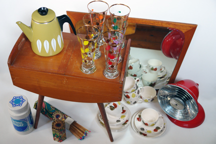 selection of vintage items recently acquired by H is for Home including an olive green Cathrineholm teapot, Lord Nelson pottery icing sugar canister, 1950s patterned pilsner glasses, beechwood sewing box, fire lighting matches with colourful tips in original hexagonal shaped, cardboard box, bright red metallic Barber Polykymatic heat generator, Danish teak framed mirror and set of Alfred Meakin "Gay Fantasy" tea trios