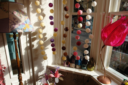 strings of colourful bauble fairy lights in the window of Radiance lighting shop on Hebden Bridge strings of colourful bauble fairy lights in the window of Radiance lighting shop on Hebden Bridge