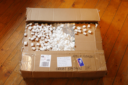 large cardboard box with overflowing packing beads