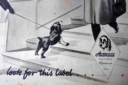 detail from a  vintage shop advertising sign for Antirain Rainwear