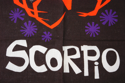detail of vintage tea towel showing "scorpio" words