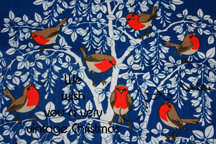 vintage linen teatowel decorated with 7 robin red breasts in a white tree